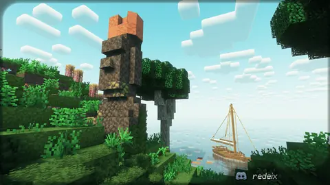 Каменная статуя головы на берегу и парусник в море